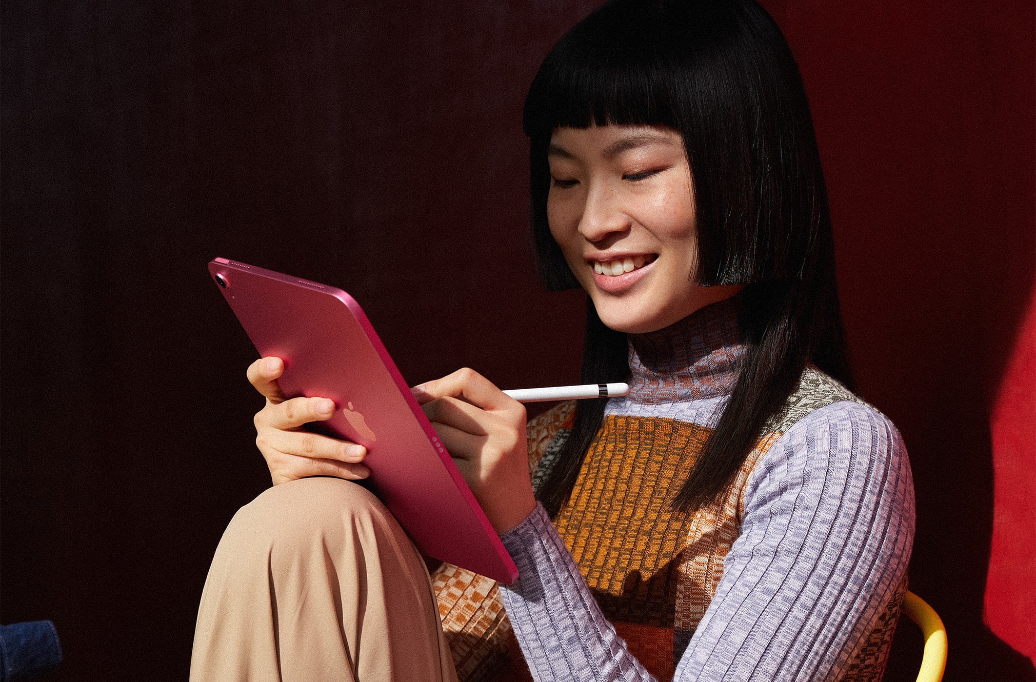 woman smiling while drawing on her tablet