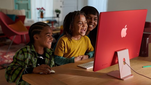 woman and kids looking up on imac m3
